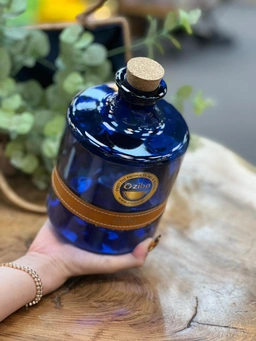بطری شیشه‌ای آبی لاجوردی مدل کلمبیا خورشیدی با بند چرمی و درب چوب‌پنبه‌ای